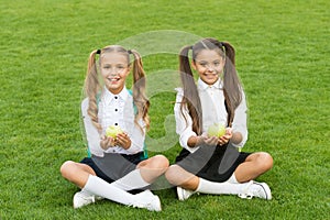 School students girls eating apples for lunch, healthy food concept