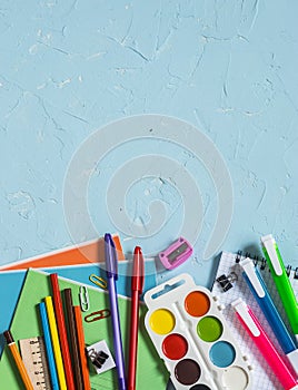 School supplies and accessories on a blue background. Free space for text. Top view.