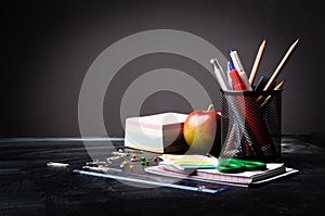 School supplies on the background of blackboard