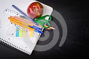 School supplies on the background of blackboard