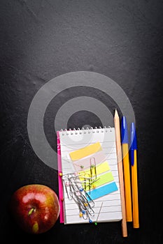 School supplies on the background of blackboard