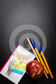 School supplies on the background of blackboard