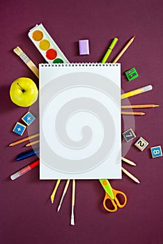 School supplies on black board background. Back to school concept. Frame, flatlay, copy space for text.