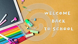 School supplies on black board background. Back to school concept