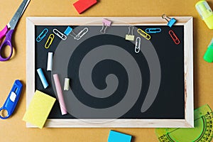 School supplies on black board background. Back to school concept