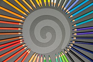 School supplies on black board background. Circle of pencils. Education, back to school concept with copy space