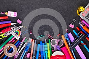 School supplies on black board background with copy space. Back to school