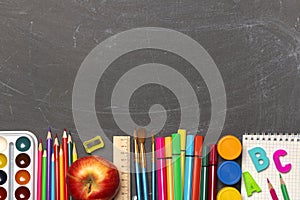 School supplies on black chalkboard background. Back to school. Banner. Concepts of study and education. copy space. Top view