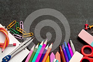 School supplies on blackboard background . The concept of education, study, learning, elearning. Back to school