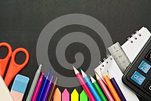 School supplies on blackboard background . The concept of education, study, learning, elearning. Back to school