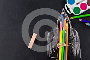 School supplies on blackboard background with copy space