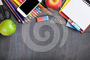 School supplies on blackboard background