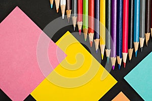 School supplies border on black chalkboard background. Top view photograph