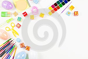 School supplies, child creativity concept flat lay. Various artistic tools for children on white desktop. Copy space