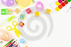 School supplies, child creativity concept flat lay. Various artistic tools for children on white desktop. Copy space