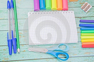 School supplies. Color pencils, plasticine, notebook, scessors, blue ballpens