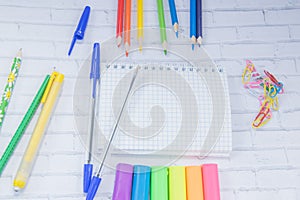 School supplies. Color pencils, plasticine, notebook, scessors, blue ballpens