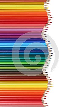 School supplies colored pencils forming a wave, education topic