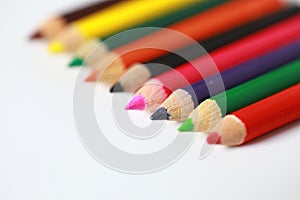 School supplies colored pencils in a row, isolated