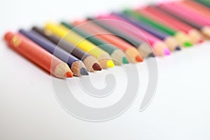 School supplies colored pencils in a row, isolated