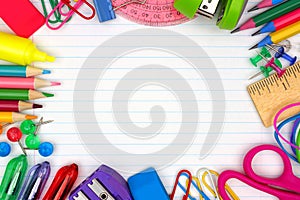 School supplies frame on lined paper background