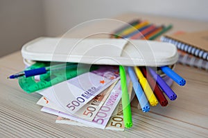 School supplies with money. Office and school supplies. Concept is to buy stationery objects