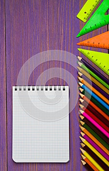 School supplies pencil, pen, ruler, triangle on blackboard bac