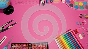 School supplies on pink board background. Education, back to school concept with copy space