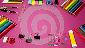 School supplies on pink board background. Education, back to school concept with copy space