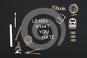 School supplies placed on black background with text learn what you hate