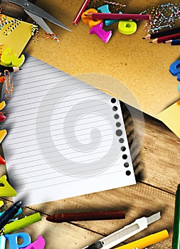 School supplies and stationery with white paper on wooden table with copyspace