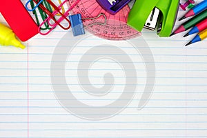 School supplies top border on lined paper background