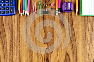 School supplies top border on wood desk background