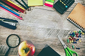 School supplies on a wooden background. Education concept. View from above. Image is tinted.