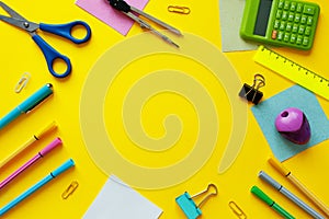 School supplies on yellow background. Back to school concept with space for text. Top view. Copy space. School office supplies