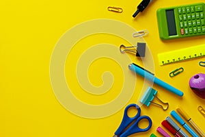 School supplies on yellow background. Back to school concept with space for text. Top view. Copy space. School office supplies