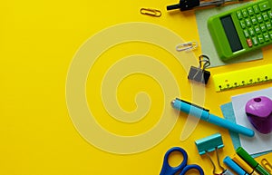 School supplies on yellow background. Back to school concept with space for text. Top view. Copy space. School office supplies