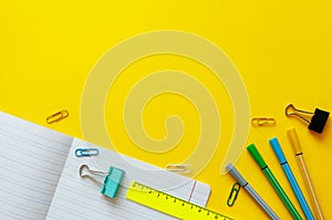 School supplies on yellow background. Back to school concept with space for text. Top view. Copy space. School office supplies