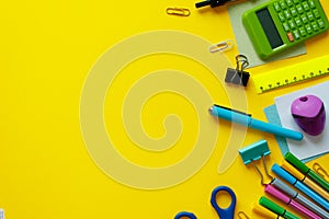 School supplies on yellow background. Back to school concept with space for text. Top view. Copy space. School office supplies