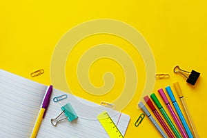 School supplies on yellow background. Back to school concept with space for text. Top view. Copy space. School office supplies