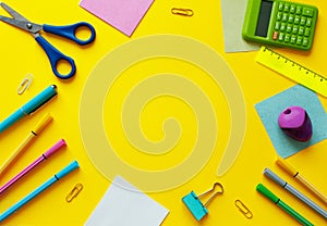 School supplies on yellow background. Back to school concept with space for text. Top view. Copy space. School office supplies