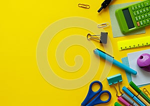 School supplies on yellow background. Back to school concept with space for text. Top view. Copy space. School office supplies