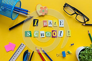 School supplies on yellow background with text I HATE SCHOOL