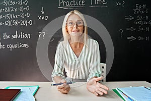 School teacher having online virtual class in classroom, webcam view.