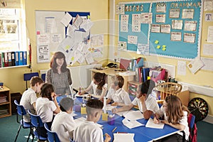 School teacher and kids work on class project, elevated view