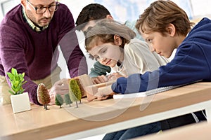 School teacher with pupils at biology class