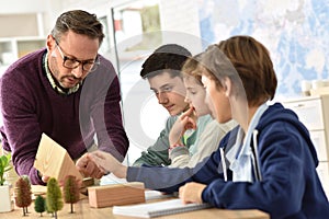 School teacher with pupils in science class