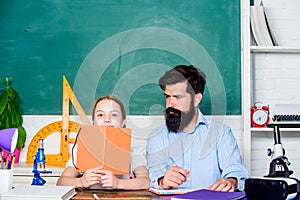 School teacher and schoolgirl. Man bearded teacher excellent pedagogue. Pedagogue skills. Talented pedagogue. Work