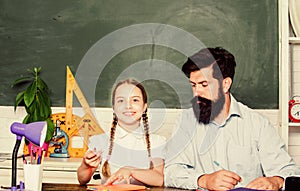 School teacher and schoolgirl. Pedagogue skills. Talented pedagogue. Work together to accomplish more. Man bearded