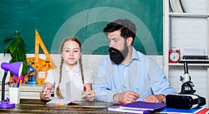 School teacher and schoolgirl. Talented pedagogue. Work together to accomplish more. Man bearded pedagogue